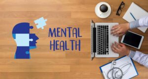 An aerial view of a man working at his desk, with the words 'mental health' written in bold beside him