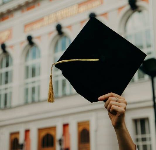 Graduation A graduate throws their graduation cap into the air