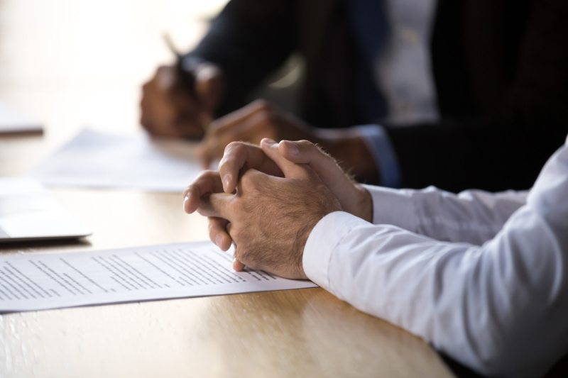 Legal professionals Two legal professionals sit at a desk and make notes during a meeting