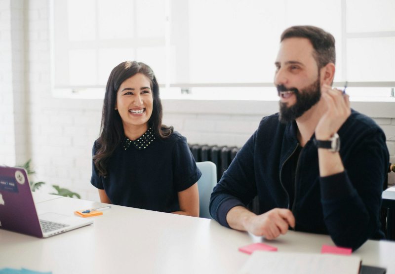Work Meeting Two cheerful legal professionals engage in a work meeting in a bright and modern office