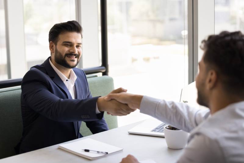 Solicitor and Client A cheerful solicitor shakes hands with a client