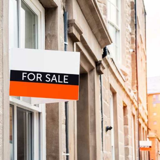 Conveyancing A "for sale" sign posted outside of a residential property
