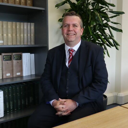 An image of Jon Bostock, the CEO of the PM Law Group