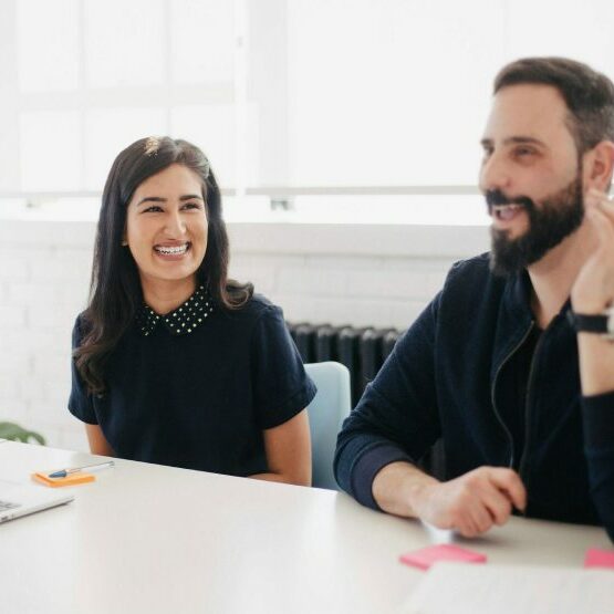 Work Meeting Two cheerful legal professionals engage in a work meeting in a bright and modern office