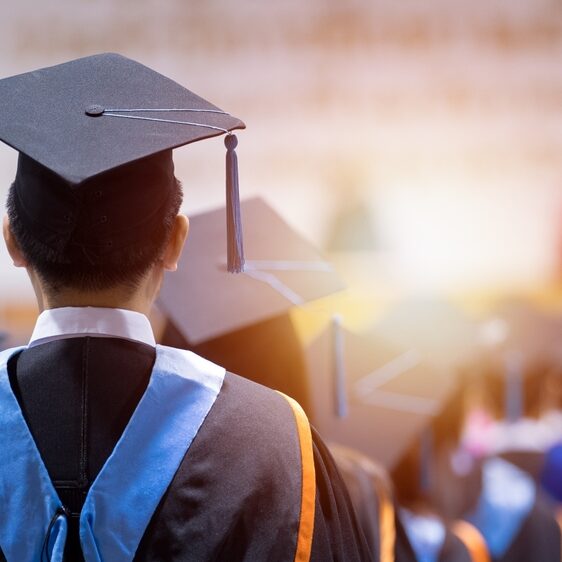 University graduates wearing graduation gown and cap