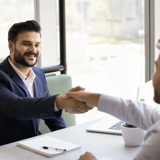 Solicitor and Client A cheerful solicitor shakes hands with a client