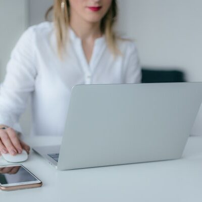 Employee Working A woman works on a laptop at her desk in a bright and modern office